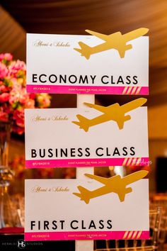 there are three signs on the table that say, economy class business class first class