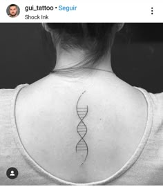 the back of a woman's neck with a tattoo on it