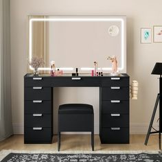 a black vanity with lights and stool in front of it