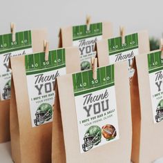 small brown bags with green and white footballs on them