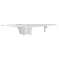 a white table that is on top of a stand with one leg up and the other end down