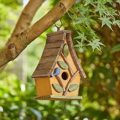 a bird house hanging from a tree branch