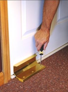 a man is using a tool to open the door