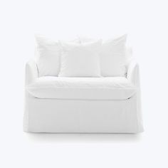 a white couch with four pillows on it