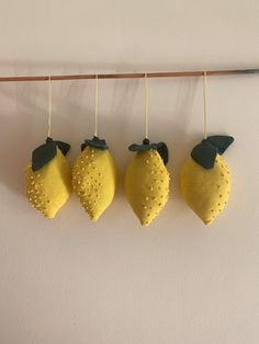 three lemons are hanging on a clothes line