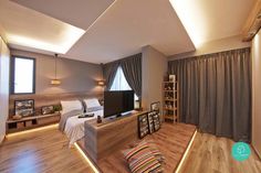 a living room filled with furniture and a flat screen tv sitting on top of a wooden floor