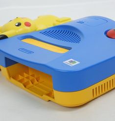 a blue and yellow plastic toy with a pikachu on it's back