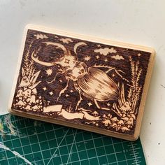 a wooden box sitting on top of a cutting board