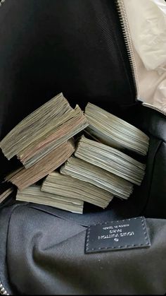 a bag filled with lots of money sitting on top of a table