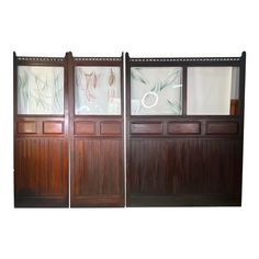 three wooden doors with frosted glass panels on the front and back, one closed