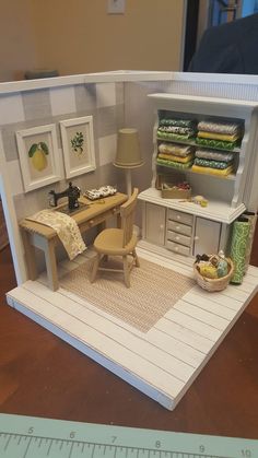 a doll house with furniture and accessories in it's display case on a table