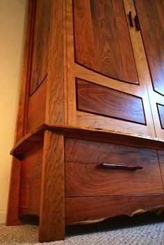 a close up of a wooden cabinet on the floor