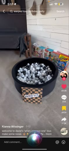 an image of a bowl full of balls in the middle of a room with toys on the floor