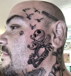 a man with tattoos on his face and neck