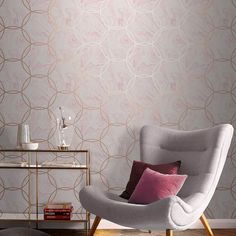 a living room scene with focus on the chair and wallpapered walls in the background