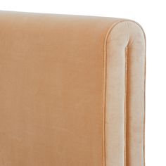 an upholstered headboard with buttons on the back and arms, in beige velvet