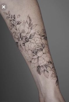 a woman's arm with flowers on it and a hand holding the other arm