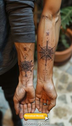 two people holding hands with tattoos on them