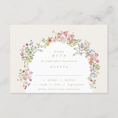 a wedding rsp card with watercolor flowers and greenery in the center on a marble background