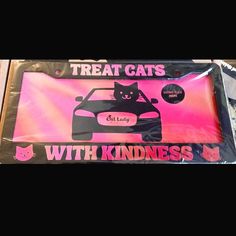 a cat is sitting on top of a car with the words, treat cats with kindness