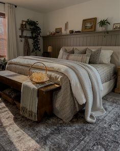 a bedroom with a large bed and lots of pillows