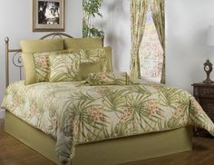 a bed with green and pink flowers on it