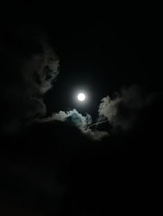 the moon is shining brightly in the dark night sky with clouds and some lightening