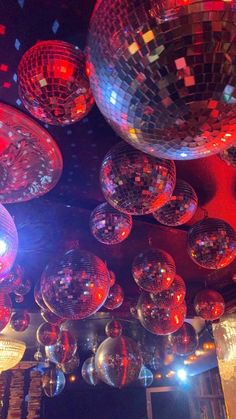 many disco balls are hanging from the ceiling