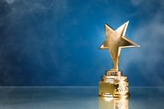 a gold star trophy sitting on top of a table