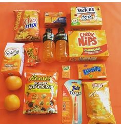 an orange table topped with snacks and drinks