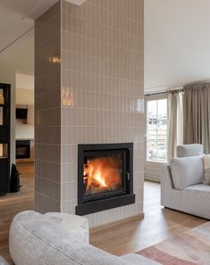 a living room filled with furniture and a fire place in the middle of the room