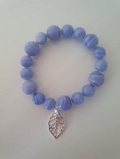 Natural blue lace agate,  elasticated handmade bracelet. Decorated with silver tone decorative accessories.  Diameter inside bracelet: 5.2 cm Weight: 25 gr  Size of stone beads: 10 mm, 12 mm. Blue Lace Agate Bracelet, Agate Bracelet, Blue Lace Agate, Handmade Bracelet, Lace Agate, Groomsman Gifts, Blue Lace, Handmade Bracelets, Stone Beads