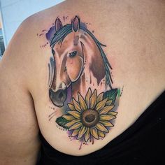 a woman with a horse and sunflower tattoo on her back