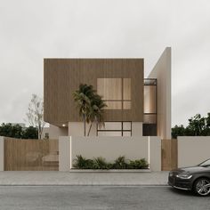 a black car is parked in front of a modern house with wooden slats on the walls