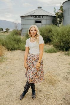 Elevate your fall wardrobe with the Mayra Skirt! This midi-length western skirt boasts a stunning floral print and comfortable elastic waistband. Perfect for any occasion, it's a must-have addition to your collection. Experience effortless style and comfort with the Mayra Skirt. Codi is wearing size small paired with The Lili Bodysuit and Ariat Casanova Boots Western Bodysuit, Western Skirts, Outdoor Girls, Curvy Dress, Heritage Collection, Fall Wardrobe, Bottoms Pants, Snap Button, Midi Length