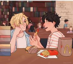 two people sitting at a table in a library, one is eating french fries and the other is holding a hot dog