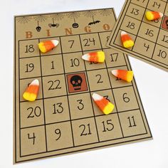 two game boards with candy corn on them and a skull in the middle for halloween