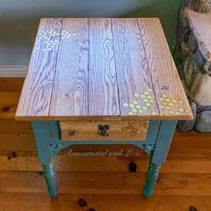 a wooden table sitting on top of a hard wood floor next to a teddy bear