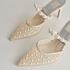 two pairs of shoes with pearls on them