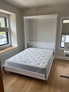 an empty bedroom with a mattress in it