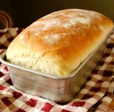 a loaf of bread sitting on top of a checkered cloth