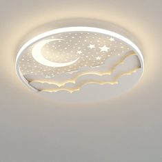 a ceiling light with stars and the moon in the sky on it's side