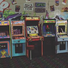 several arcade machines lined up against a wall