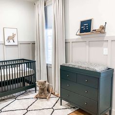 a baby's room with a crib, dresser and teddy bear in it