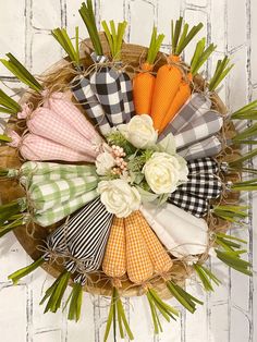 an arrangement of napkins arranged in a basket on a white wooden background with greenery