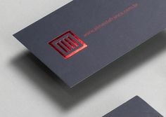 the business card is designed to look like it has a red letter on it and an embossed logo