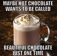 a mug filled with hot chocolate sitting on top of a counter next to a sign that says, maybe hot chocolate wants to be called beautiful chocolate just one time