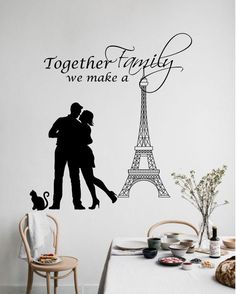 a couple kissing in front of the eiffel tower wall decal that says together family we make a love story