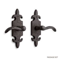 two black iron door handles on a white background