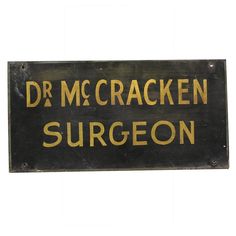 a black and gold sign that says dr mccracken surgeon on it's side